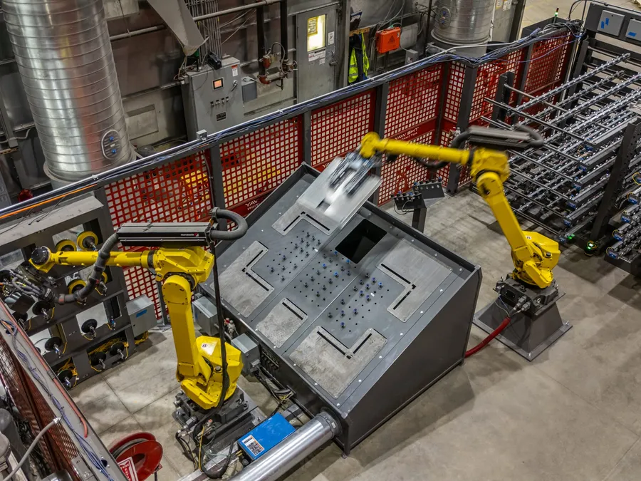 The finishing cell from above, both arms at the fixture table